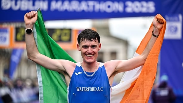 26 October 2025; David McGylnn of Waterford AC crosses the finish line to win the men's national title at the 2025 Irish Life Dublin Marathon. Photo by Sam Barnes/Sportsfile 