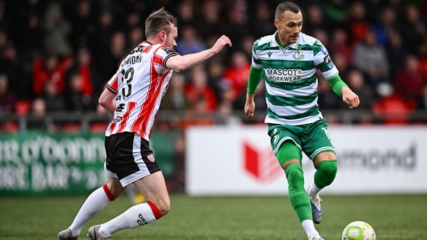 26 October 2025; Graham Burke of Shamrock Rovers in action against Cameron Dummigan of Derry City during the SSE Airtricity Men's Premier Division match between Derry City and Shamrock Rovers at The Ryan McBride Brandywell Stadium in Derry. Photo by Seb Daly/Sportsfile